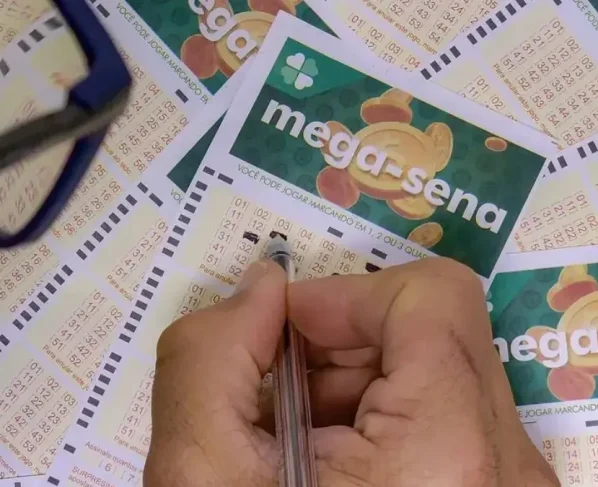 Mão preenchendo jogo da Mega-Sena